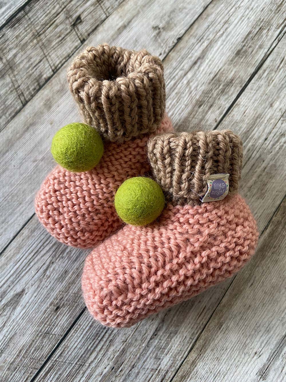 Hand knit Pink Baby Booties by Lilly and Bright with green pom pom with drawstring bag