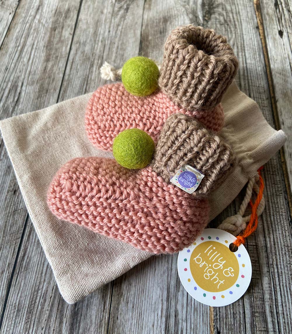 Hand knit Pink Baby Booties by Lilly and Bright with green pom pom - side view
