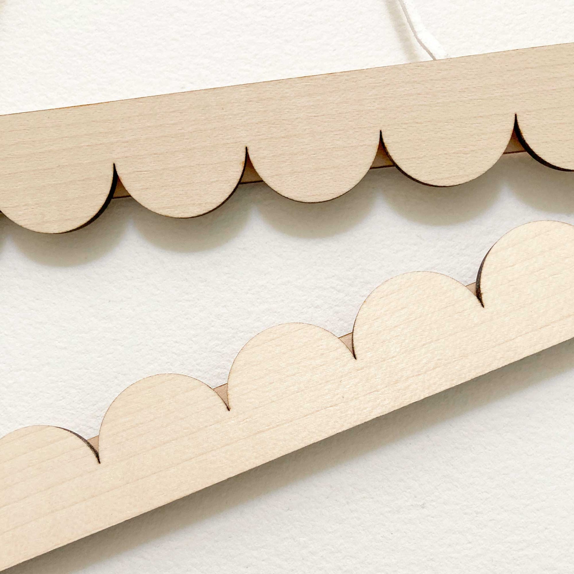 A4 Scallop edged poster hanger close up