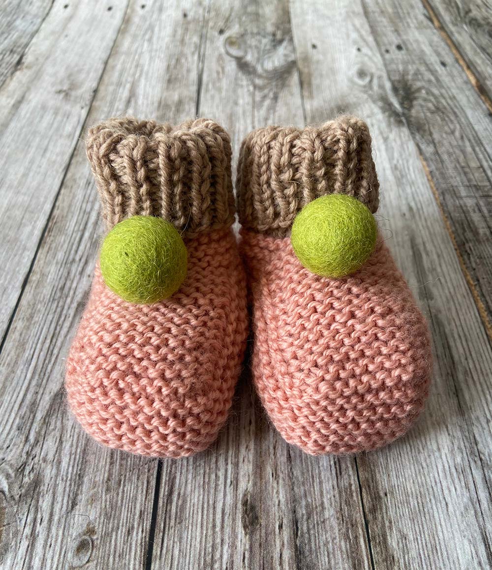 Hand knit Pink Baby Booties by Lilly and Bright with green pom pom