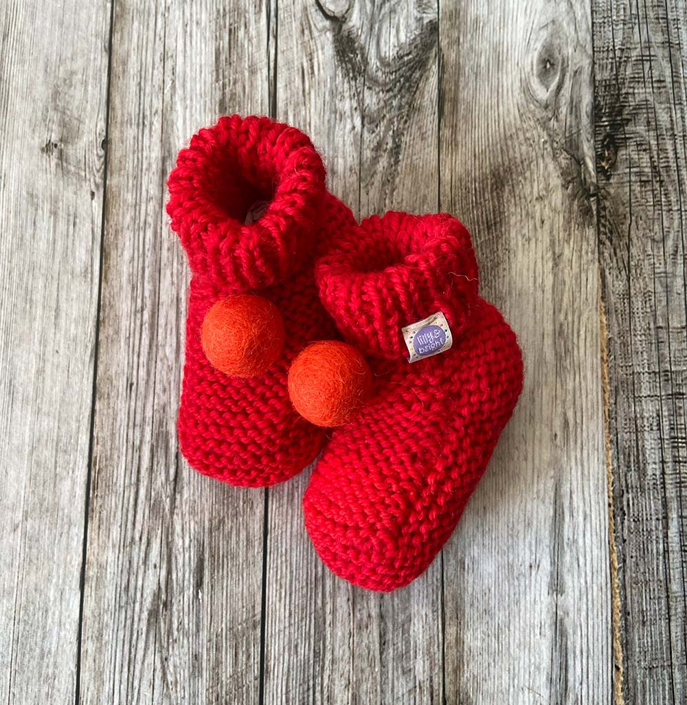 Hand knit Red Baby Booties by Lilly and Bright with orange pom pom