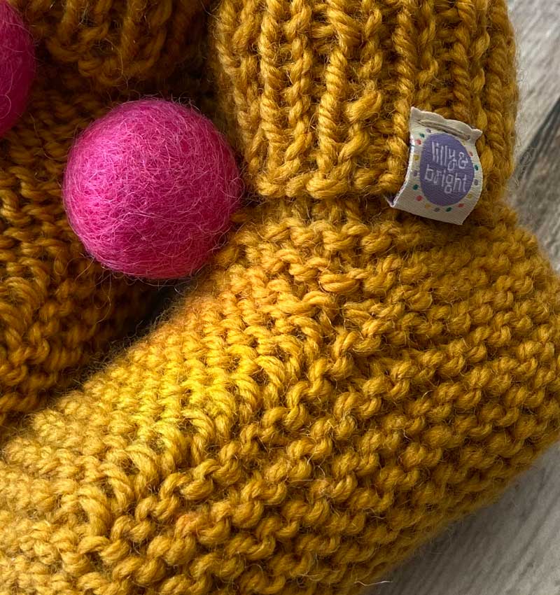 Mustard handknitted Baby Booties close up by Lilly & Bright